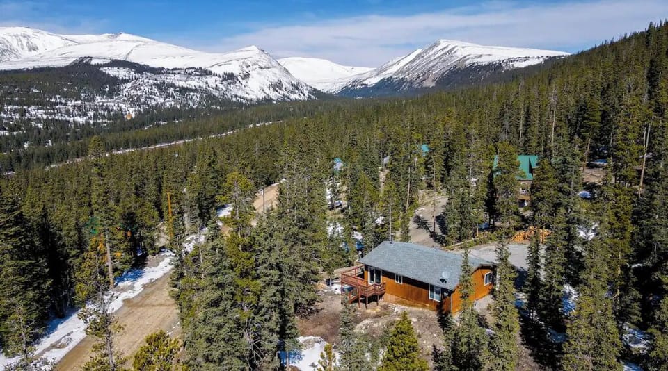 Arial view of cabin with 14ers in background.