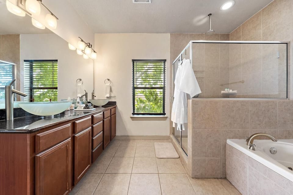 Primary bathroom with dual sinks, makeup pads, and q-tips.