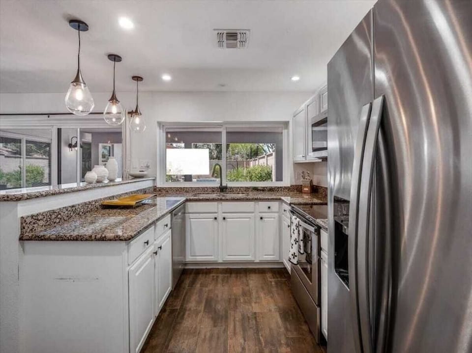 Whip up your favorite meals in this bright, fully-equipped kitchen with granite countertops, stainless appliances, and plenty of prep space for memorable vacation dining.
