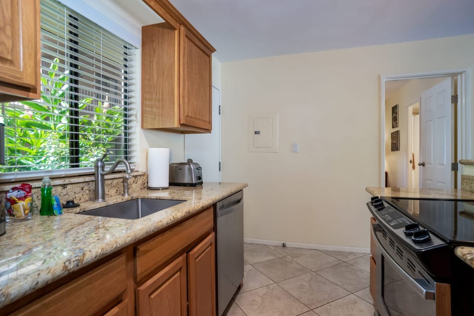Well stocked kitchen with flat top stove~ dishwasher~ fridge