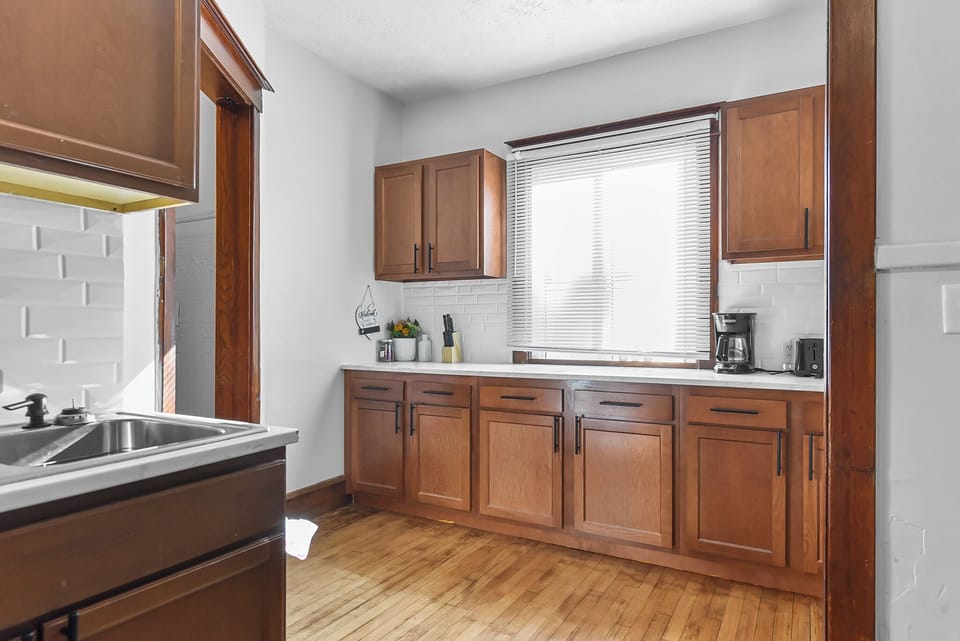 Cook your favorite meals in this bright, fully-equipped kitchen with warm wood cabinets, modern appliances, and plenty of counter space for your culinary adventures.