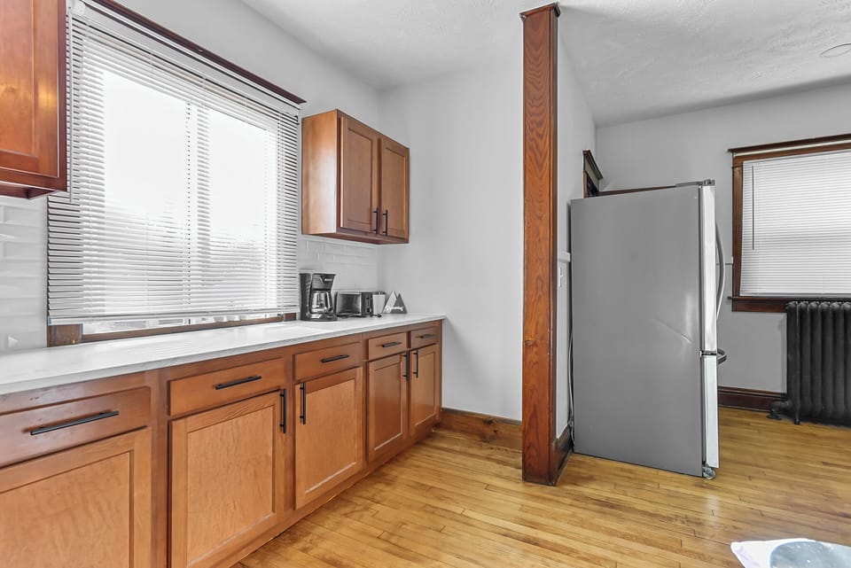 Your fully equipped kitchen features warm wood cabinets, modern appliances, and everything you need to prepare meals during your stay.