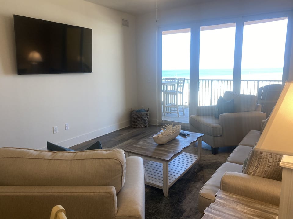 Living area with 65” smart tv with cable view of gulf direct access to balcony 