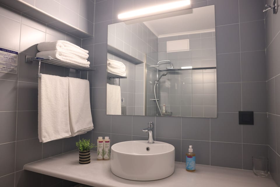 Shower, rainfall showerhead, designer toiletries, hair dryer