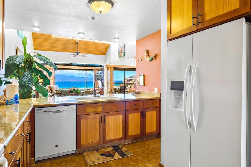 Prepare meals with ease in your fully equipped kitchen featuring granite countertops and custom cabinetry.