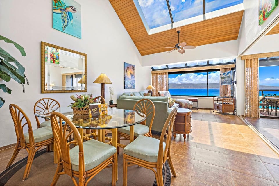 The living area blends indoor comfort with natural light and tropical surroundings, plus a sofa sleeper for extra guests.