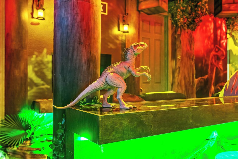 Discover a vibrant lounge filled with lush greenery and eye-catching murals, where cozy seating invites you to relax and colorful lighting adds a lively touch to your experience. Enjoy the playful atmosphere during your stay!