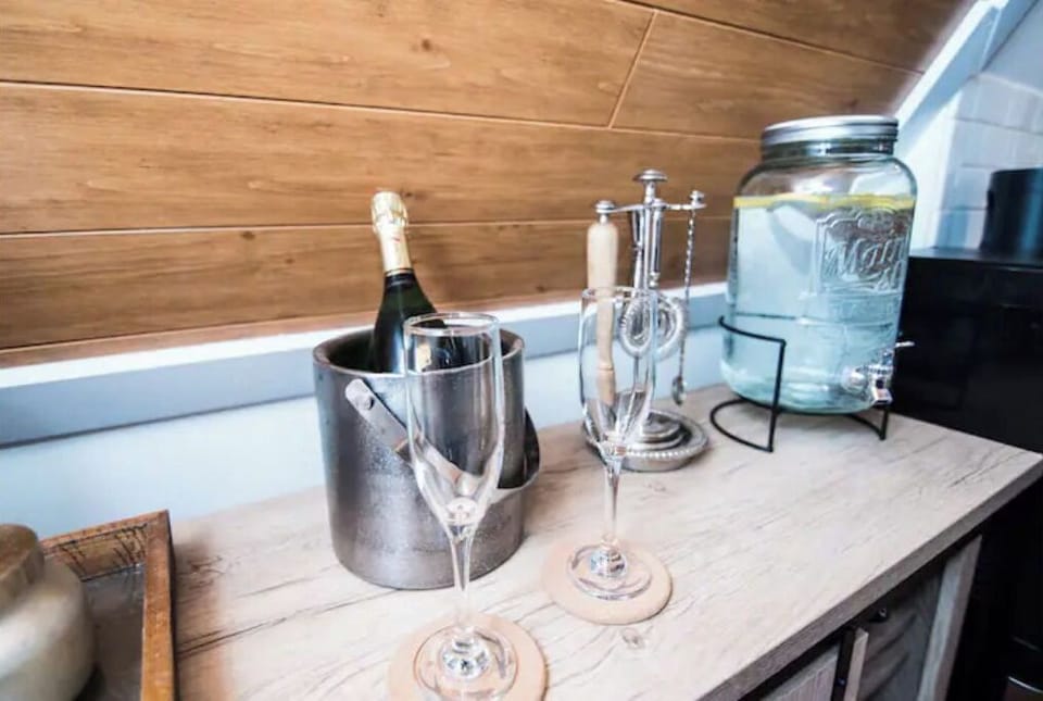 Bar with has several types of glasses and cocktail/wine utensils 
