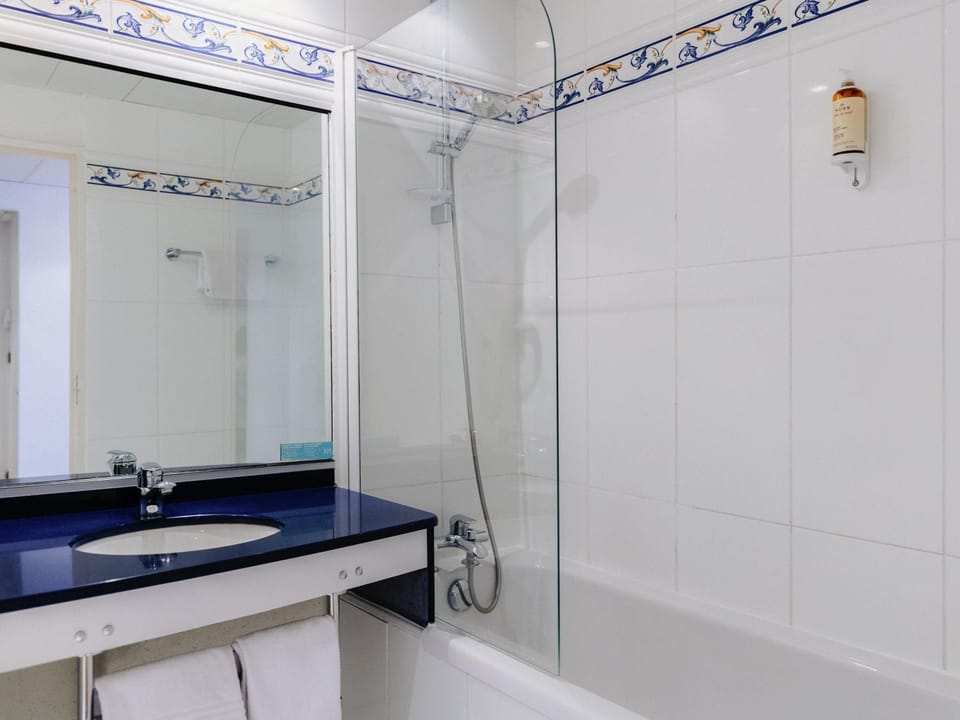 Bathtub, eco-friendly toiletries, hair dryer, towels