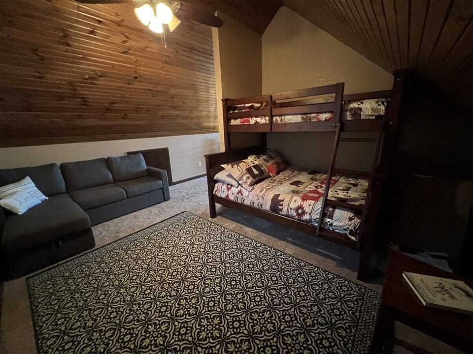 Loft sleeping area with full/twin bunk and sleeping couch