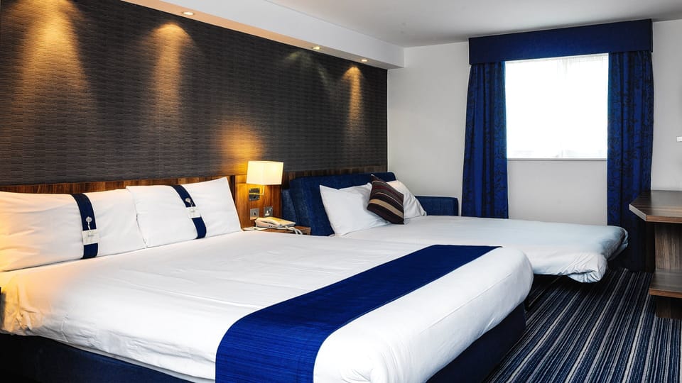 Desk, laptop workspace, iron/ironing board, free cribs/infant beds