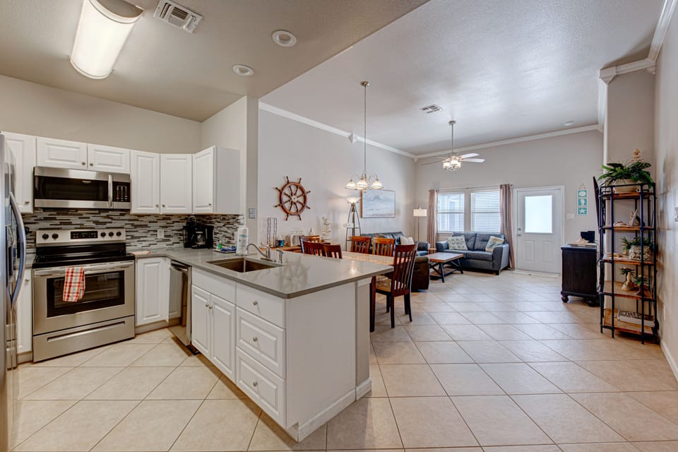 Cook together in your spacious kitchen featuring sleek appliances, granite counters, and an open design that flows into your cozy living area.