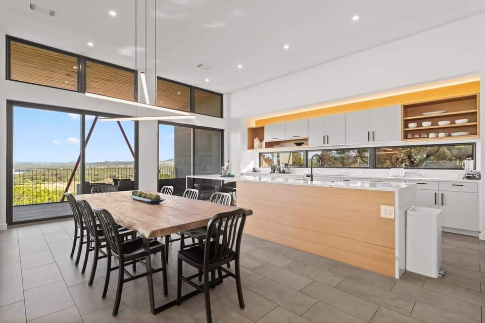 Dining space for 8 with expansive windows and natural light