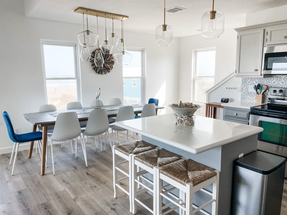 There is seating for 10 at the dining table and 3 more at the island.