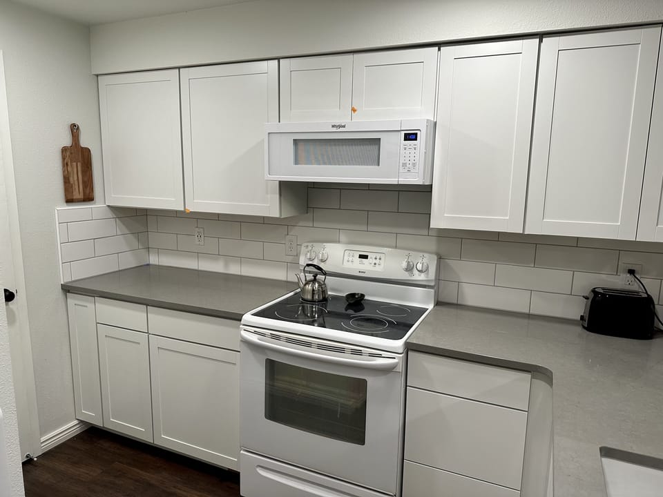 Beautiful new kitchen fully stocked with cookware, spices and some pantry basics