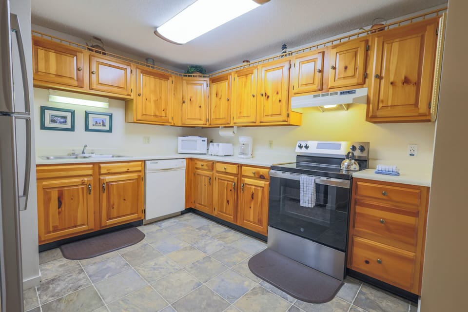 Kitchen has full size appliances and is fully stocked with silverware, dishware, glassware, cooking utensils and pots & pans.
