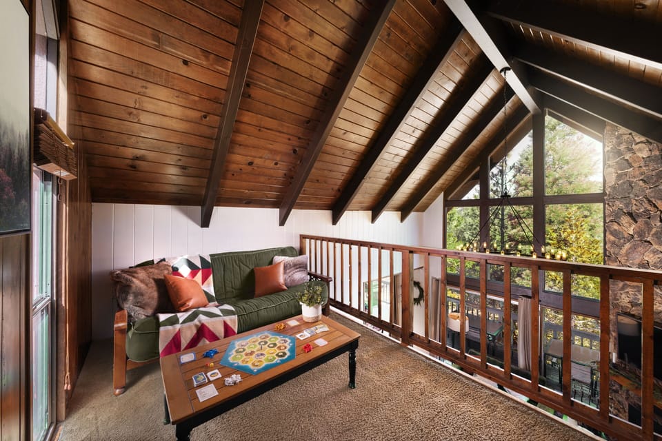 Sleep, relax, or game up in the loft overlooking stunning forest views
