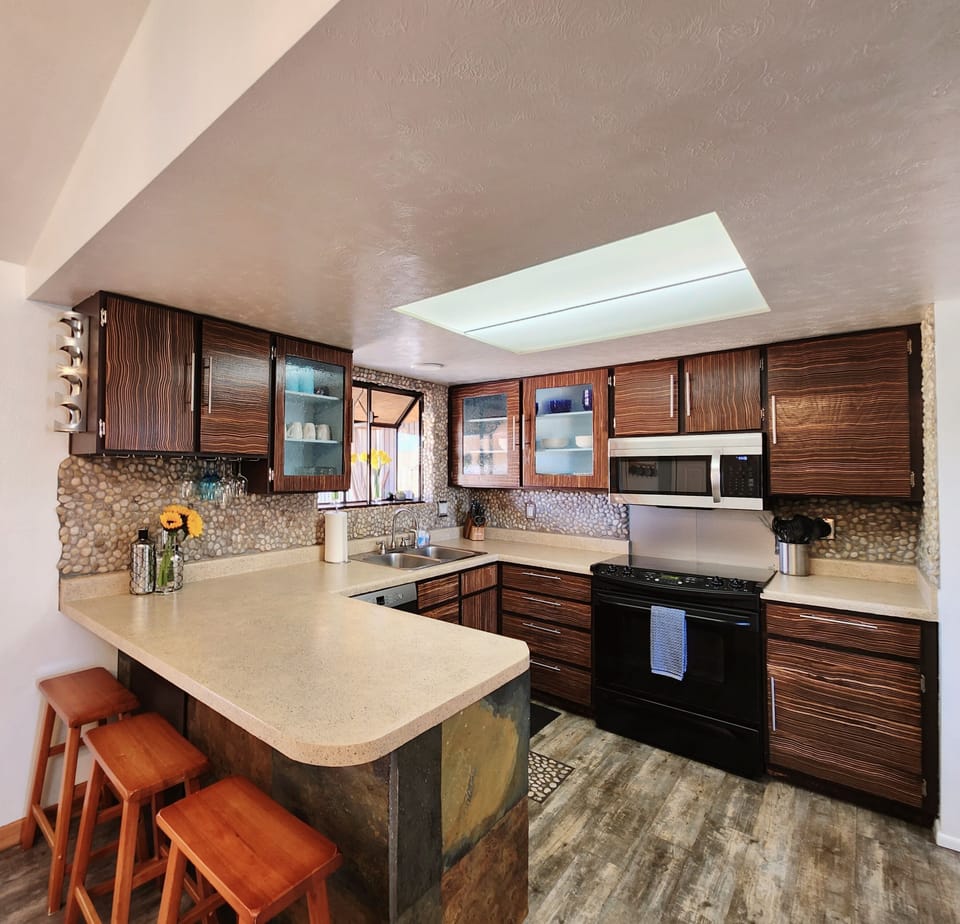 Kitchen offers dishes, and cookware as well as counter seating