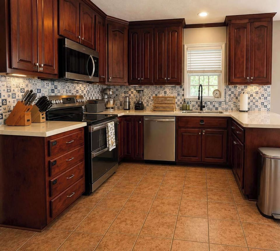 You'll enjoy the large kitchen area with lots of counter space. Two bar stools not pictured. Kitchen nook is to right - perfect for family gatherings so you can cook and converse with your family.