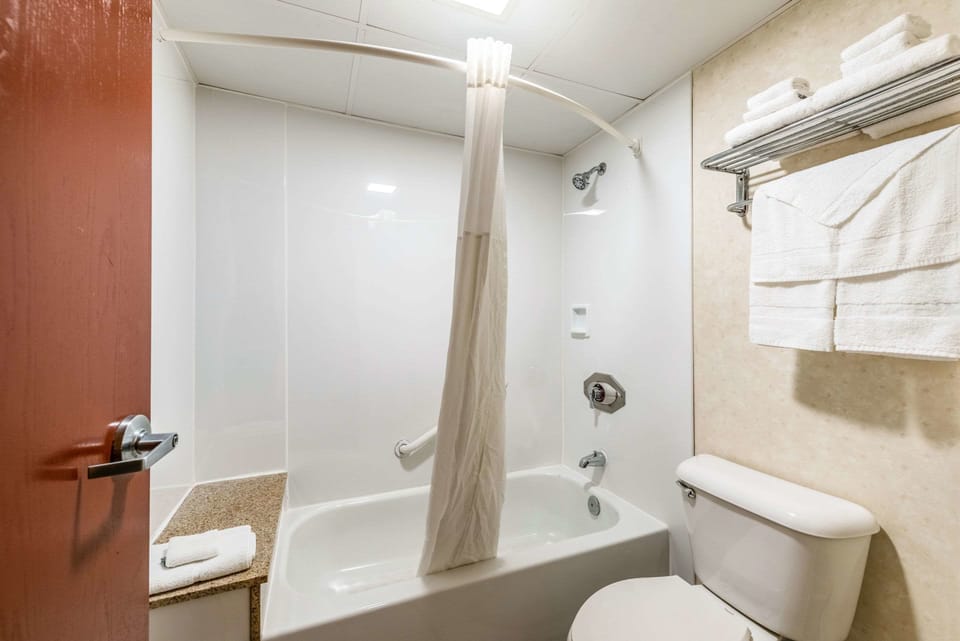 Desk, laptop workspace, blackout drapes, iron/ironing board