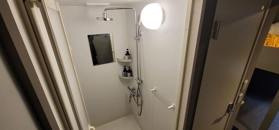 Economy Twin, Non Smoking | Bathroom | Shower, free toiletries, hair dryer, slippers