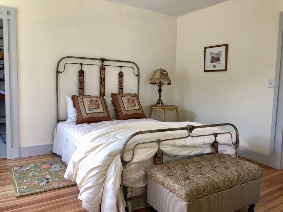 This first floor queen bedroom has a ceiling fan, mini-split A/C and bathroom.