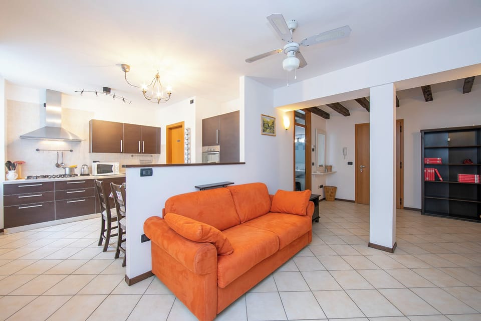 Family Apartment, Multiple Bedrooms (Casa Azzurra 150m From Lake) | Living area | 21-inch flat-screen TV with cable channels