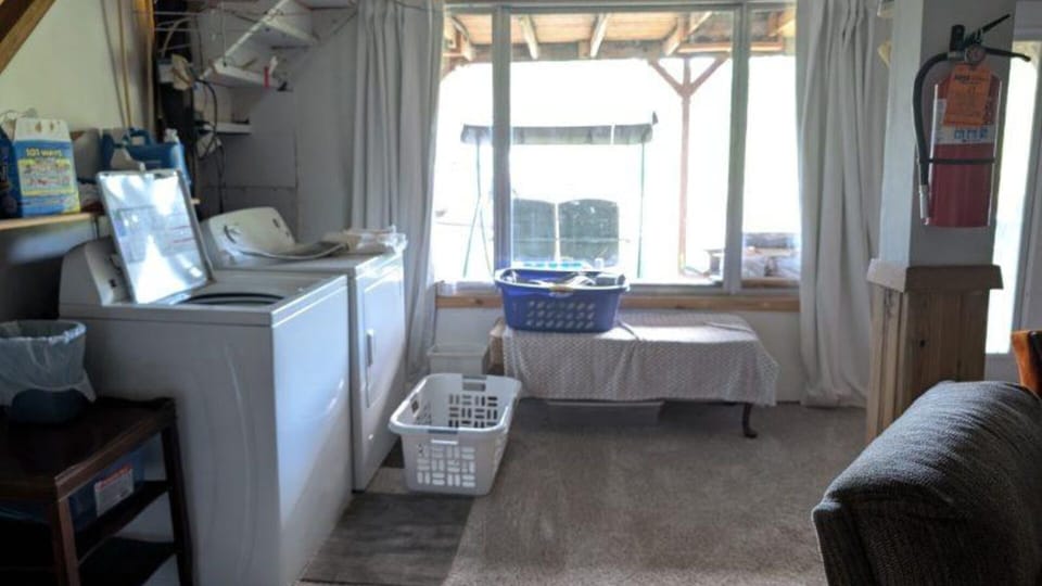 washer and dryer and view out lower level picture window