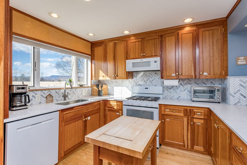 The cherry kitchen with new counters and backsplash