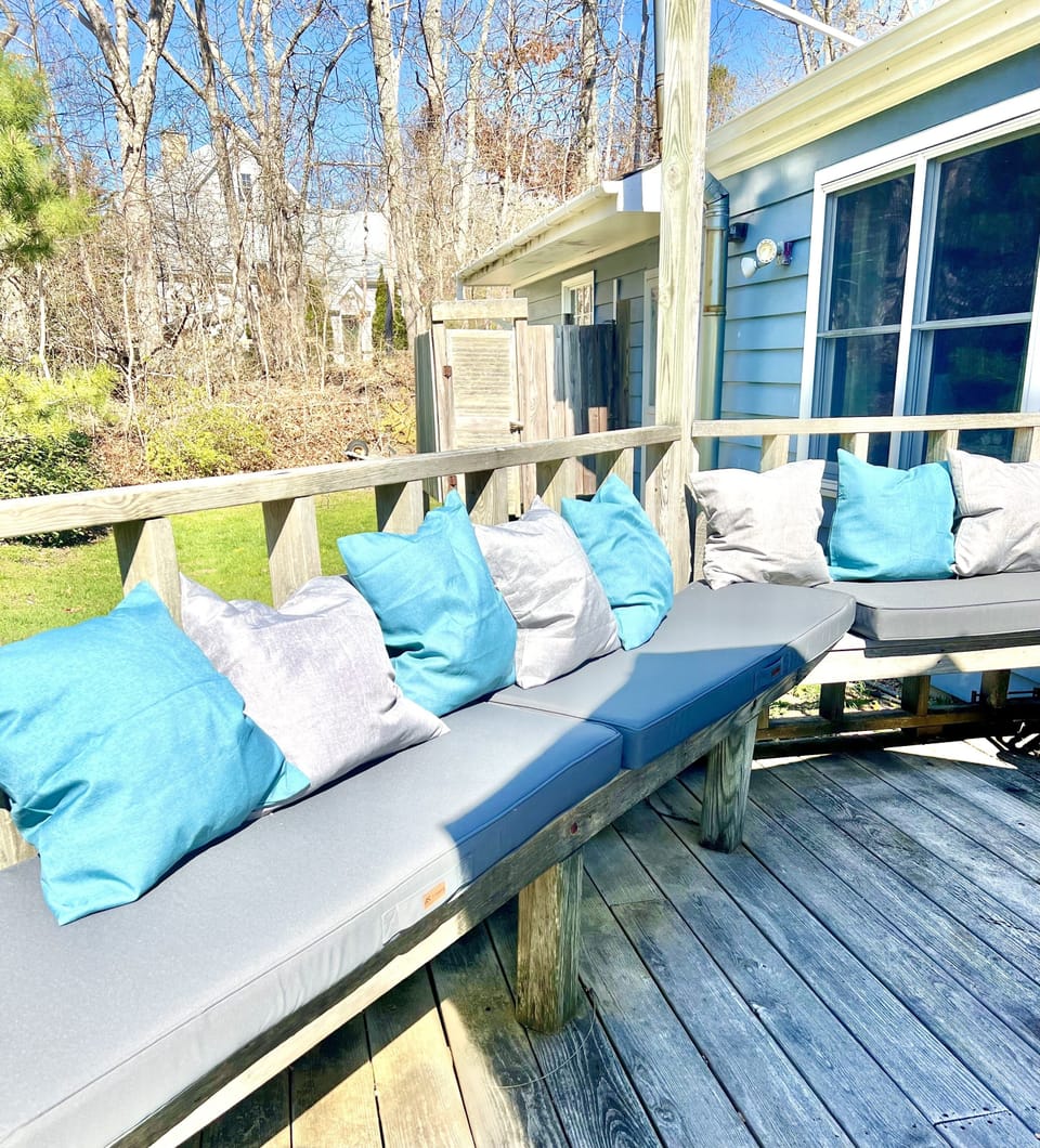 Great huge deck sit on the cushioned bench or the large umbrella table 