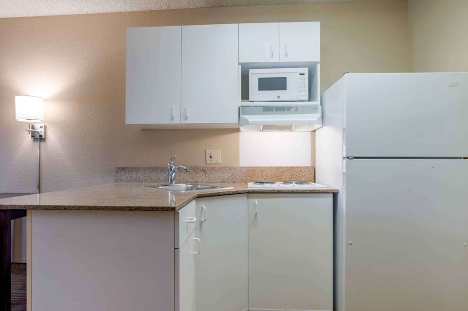 Studio (One King Bed, Non-smoking) | Private kitchen | Fridge, microwave, stovetop, coffee/tea maker