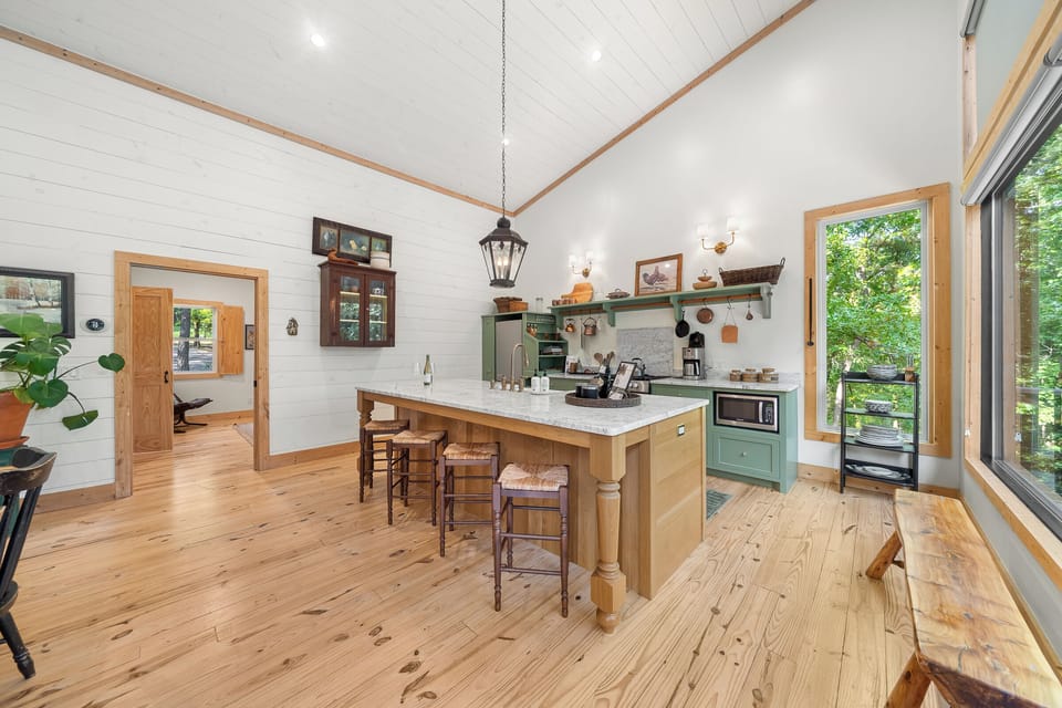 Kitchen: Cook and connect in this bright, stylish space with views of nature just outside!