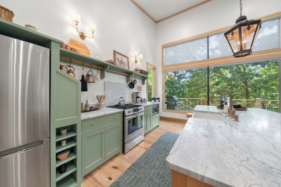 Kitchen: Cook and connect in this stunning space with panoramic views and stylish modern accents!