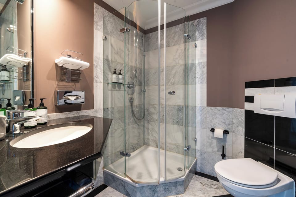 Shower, designer toiletries, hair dryer, slippers