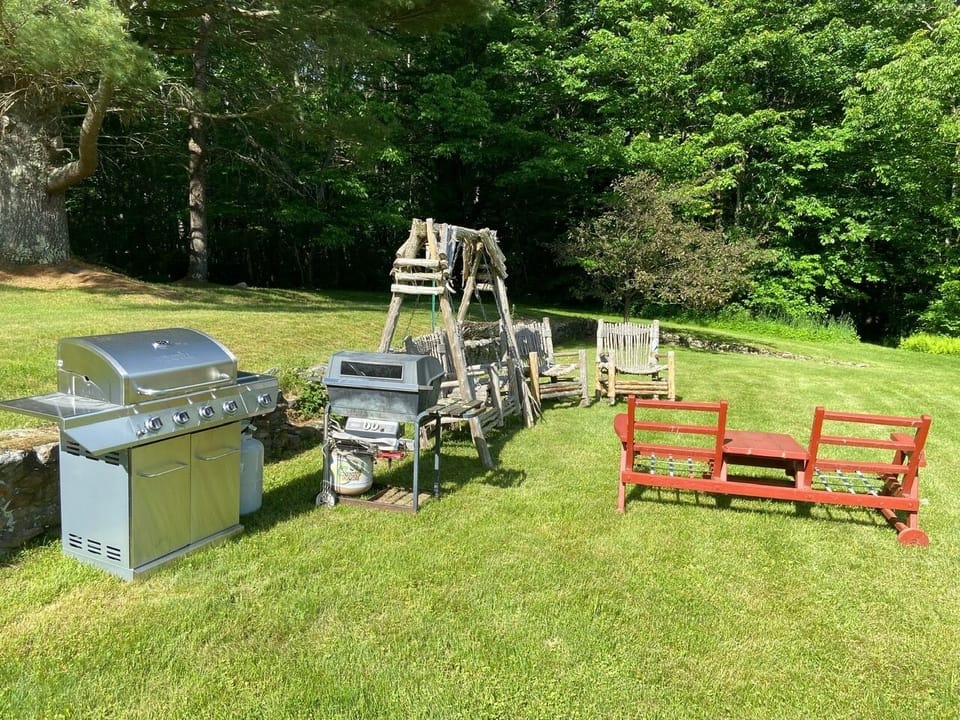 BBQ and sitting area. Large picnic table and seats for 15-20 people