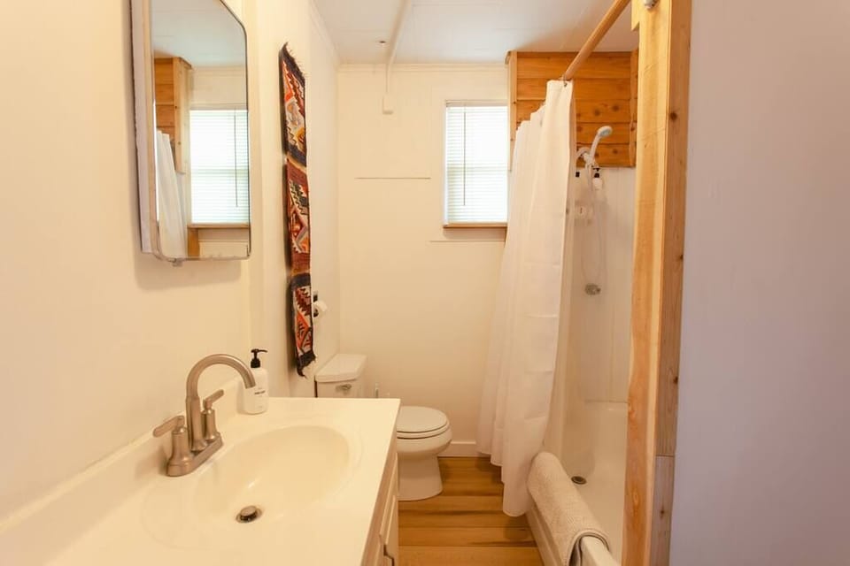 A well-lit bathroom featuring modern fixtures, a spacious shower, and thoughtful décor accents for a fresh start to the day.