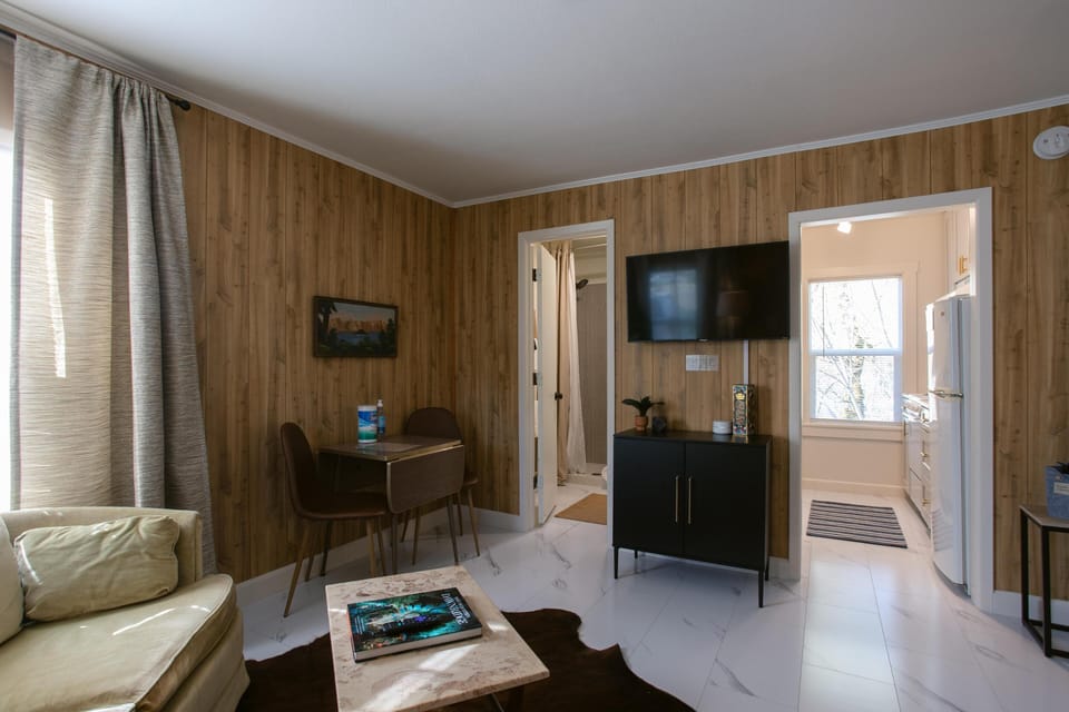 Unwind in the living room, featuring a cozy atmosphere and a Roku TV for endless entertainment, perfect for a relaxing night in or catching up on your favorite shows.