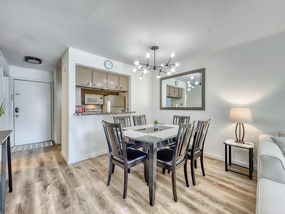 The dining area includes a large 6 person solid wood dining table