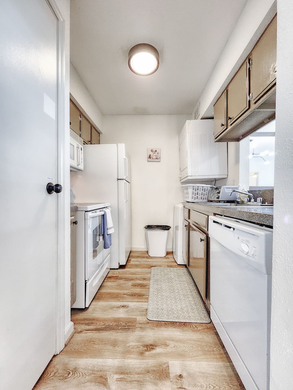 The functional kitchen includes a stove, toaster, coffee machine, and dishwasher