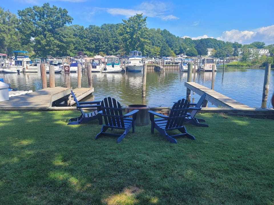 Chill by the firepit overlooking the river, waving to the boats passing by
