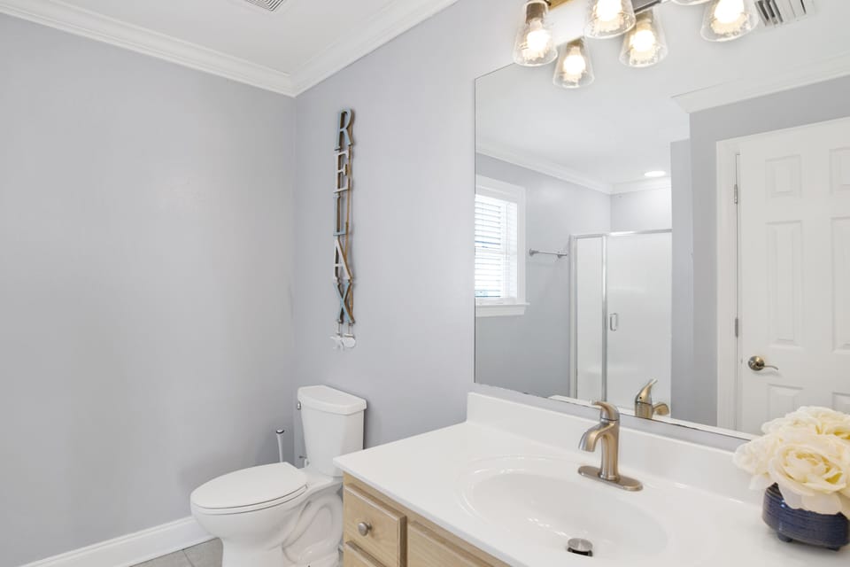 Full bath with shower and calming beach décor