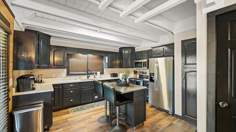 Kitchen is fully equipped with all new appliances, breakfast island, and kitchen cooking accessories.