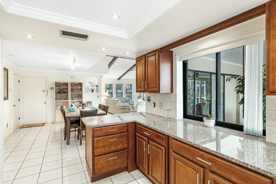 The kitchen has a sliding window so you can easily transport food and drinks out to the pool area