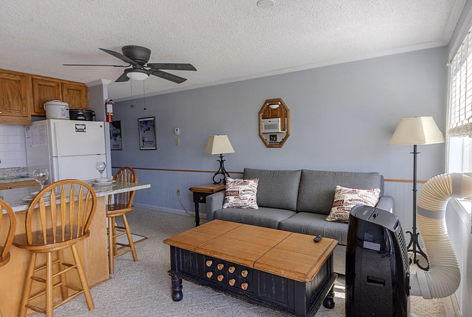The cozy living room with sofa pullout bed sleeps up to two people.
