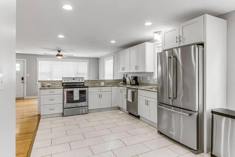 Fully equipped with stainless appliances—large fridge, stove, oven, dishwasher, and coffee maker.