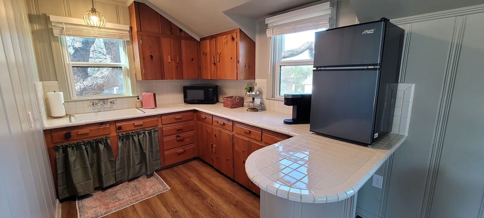 The kitchenette with a sink, microwave. toaster, kettle, Keurig and mini-fridge.