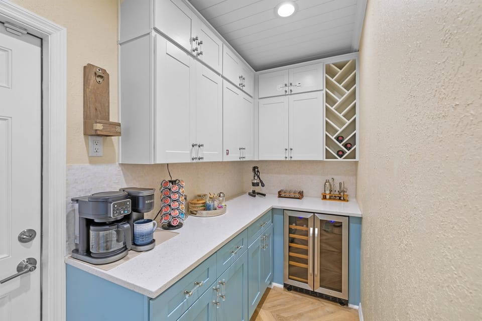 Private butler’s pantry with coffee station, beverage fridge, wine storage, and everything needed for sunset cocktails.