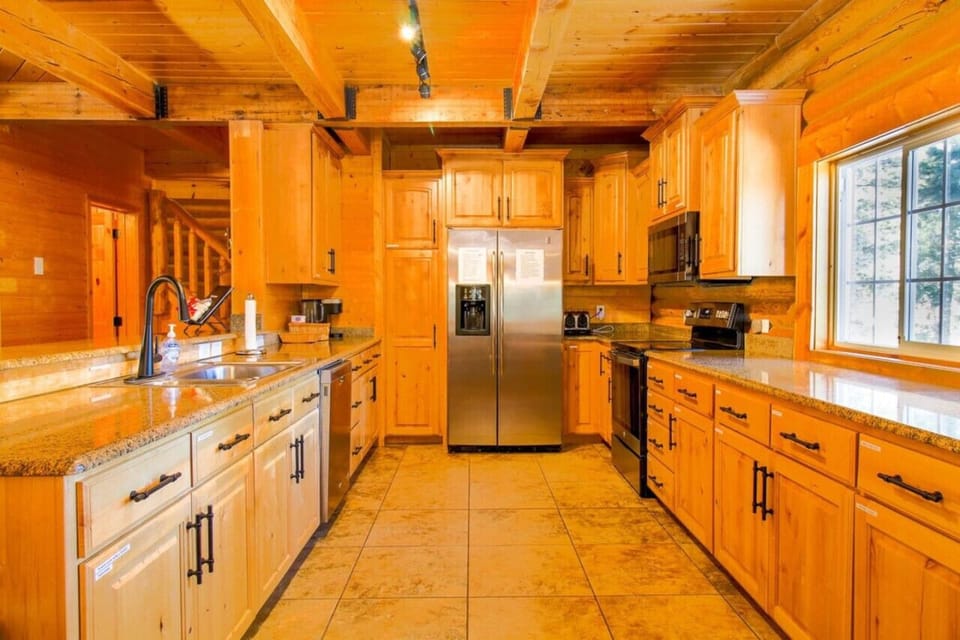 The gourmet kitchen has plenty of space to make your favorite meals with modern appliances and beautiful stone countertops.