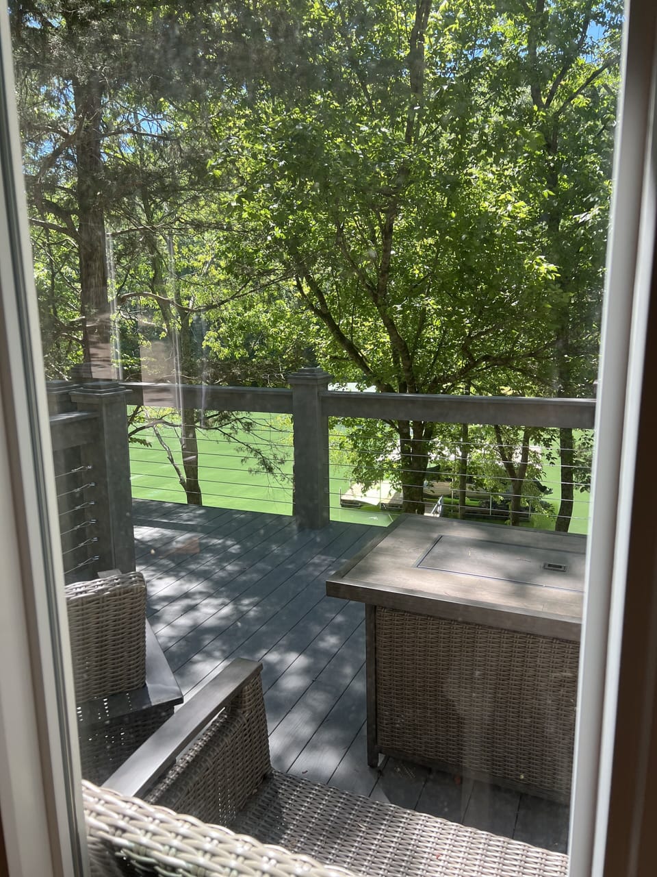 View of deck from master bedroom window. Roasting smores in the firepit is yum! 