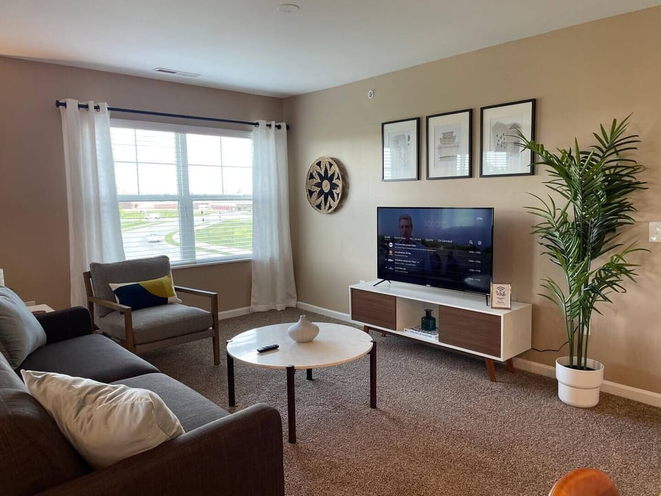 Spacious living area with large window and plenty of natural light.